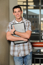 college student holding a laptop 