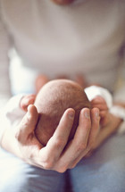 father holding a newborn baby 