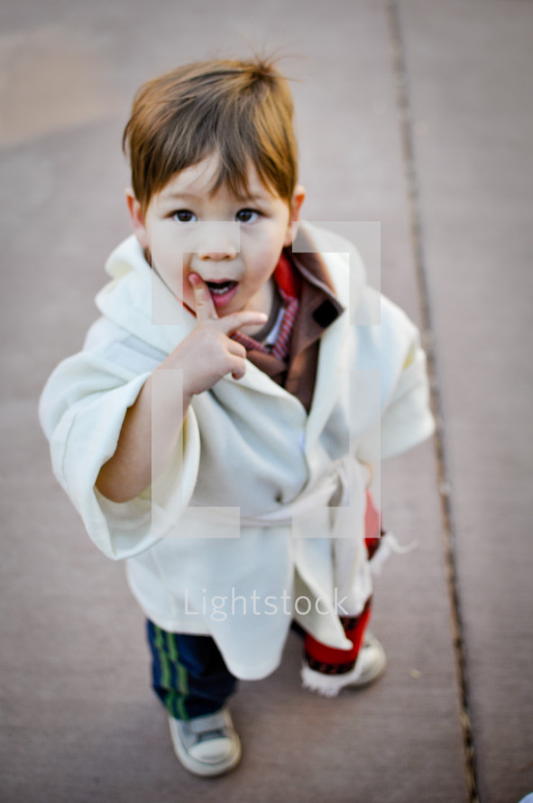 a toddler in a shepherds robe for a Christmas pageant 