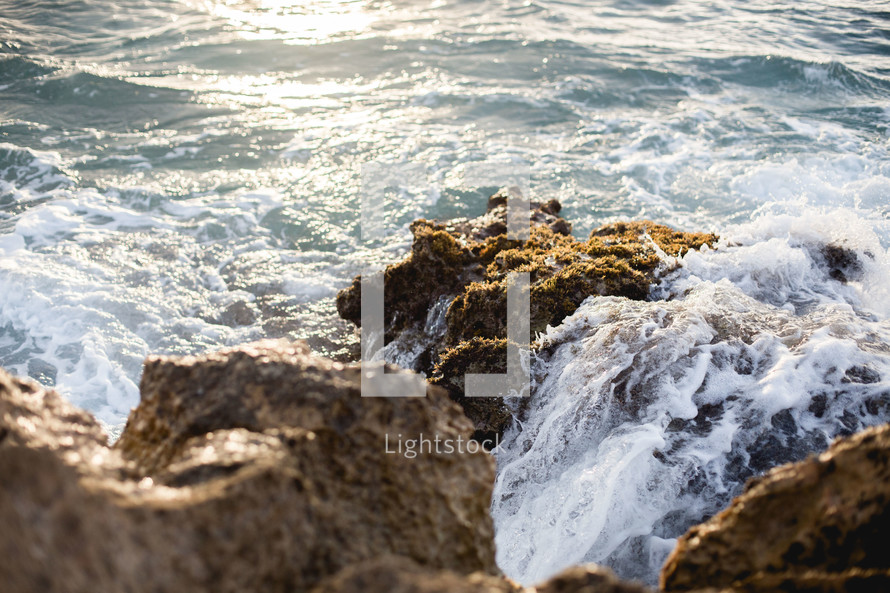 tide and waves crashing into rocks 