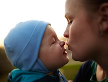 Little boy kissing his mom