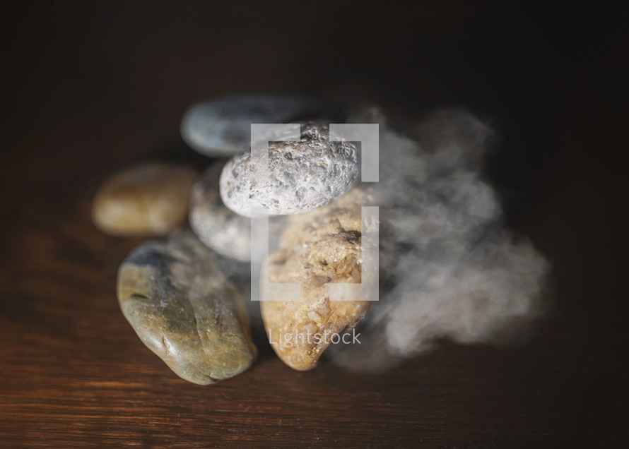 pile of rocks with cloud of smoke