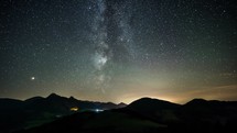 Time-laspe milky way and stars over mountains landscape
