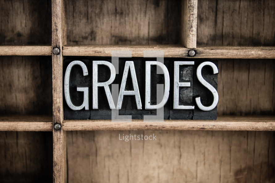 word grades in blocks on a bookshelf 