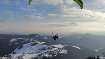 Free flight on paragliding wing in winter mountains, Freedom adventure

