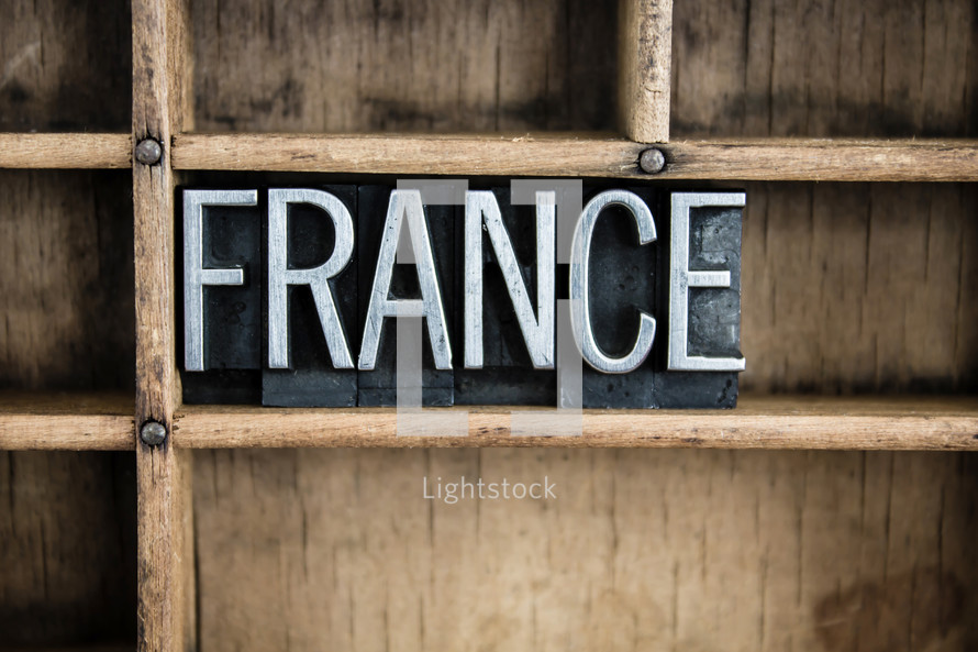 word France in blocks on a bookshelf 