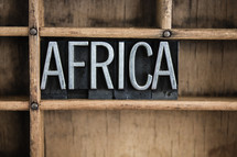 word Africa in blocks on a bookshelf 