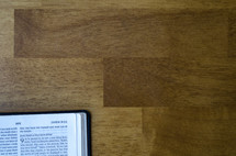 edge of a Bible on a wood table