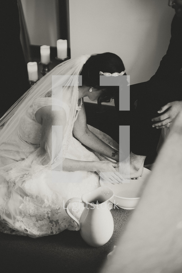 a bride washing her grooms feet 