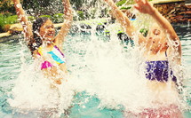 girl children splashing in a pool