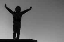 a child with raised hands 