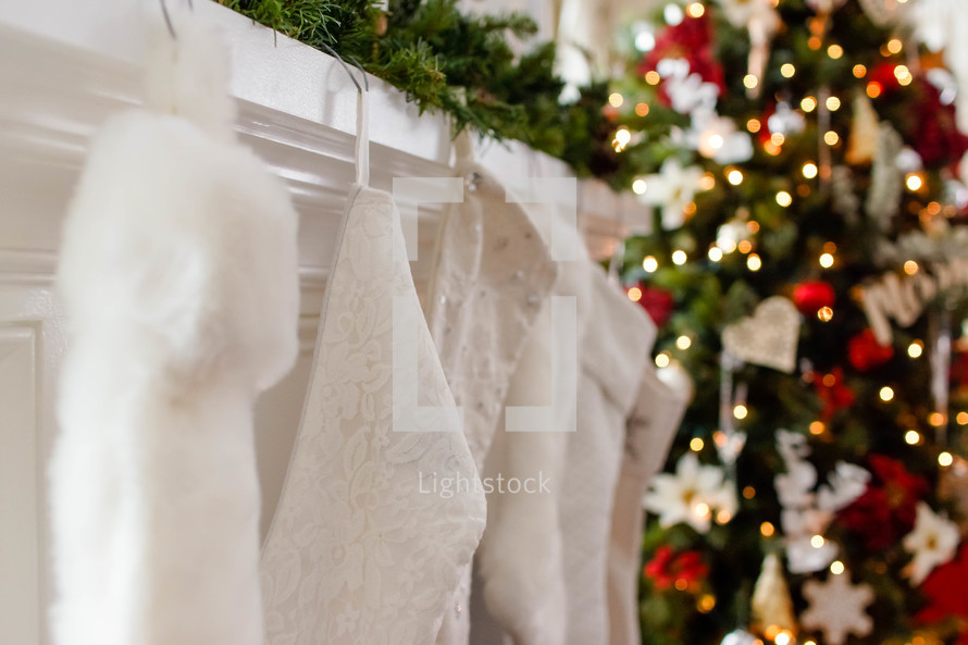white Christmas stockings on a mantel 
