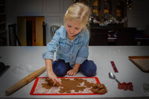 a girl baking Christmas cookies 
