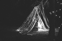 tent made out of ribbons and strings of light