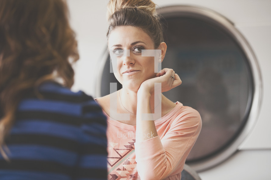 women in conversation at a laundromat