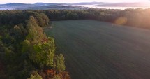 aerial view over a field at sunrise 