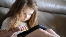 an inquisitive child using a tablet 