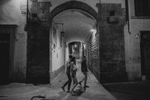 people walking on the narrow streets of Italy at night 