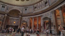 Rome, Italy - September 2023. Travelers and sightseeing tourists visit Pantheon, walking, taking picture inside during tour. Concept of holidays.
