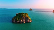 Aerial drone video of tropical paradise exotic island bay. An idyllic, remote island is surrounded by coral reef. 