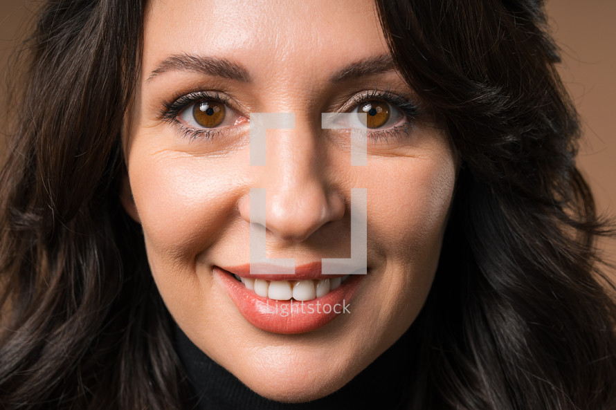 Stylish Brunette Woman Portrait, Close-Up. Natural Beauty. Mature Lady On Beige.