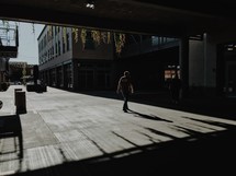 a man walking across a courtyard 