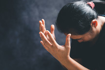 Woman raising her hands in prayer