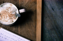 notes in a journal and a latte 