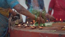 Burning incense and worshiping Hindu idols at an altar at The Varaha Lakshmi Narasimha Hindu temple. 