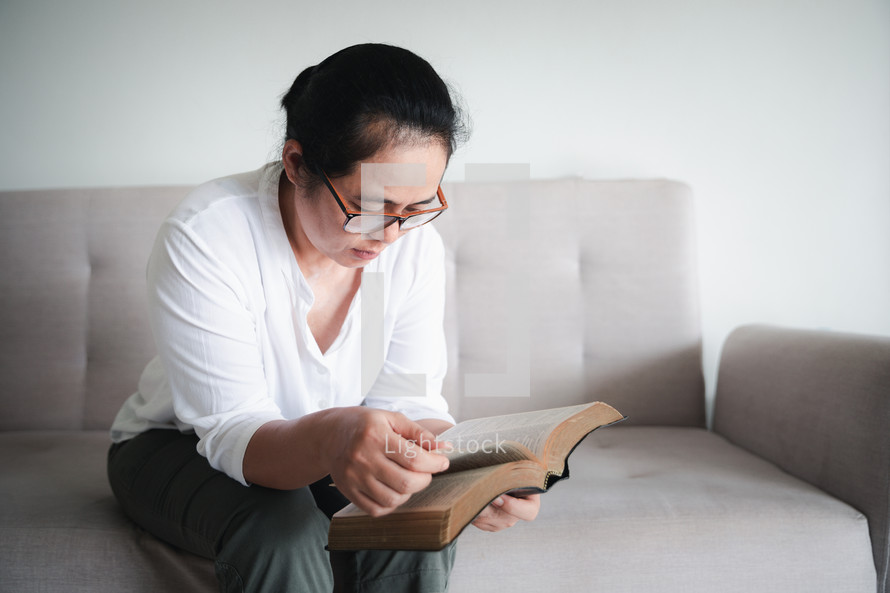 Asian woman reading a Bible