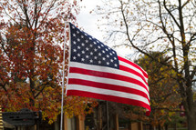 An American flag on a flagpole in fall 