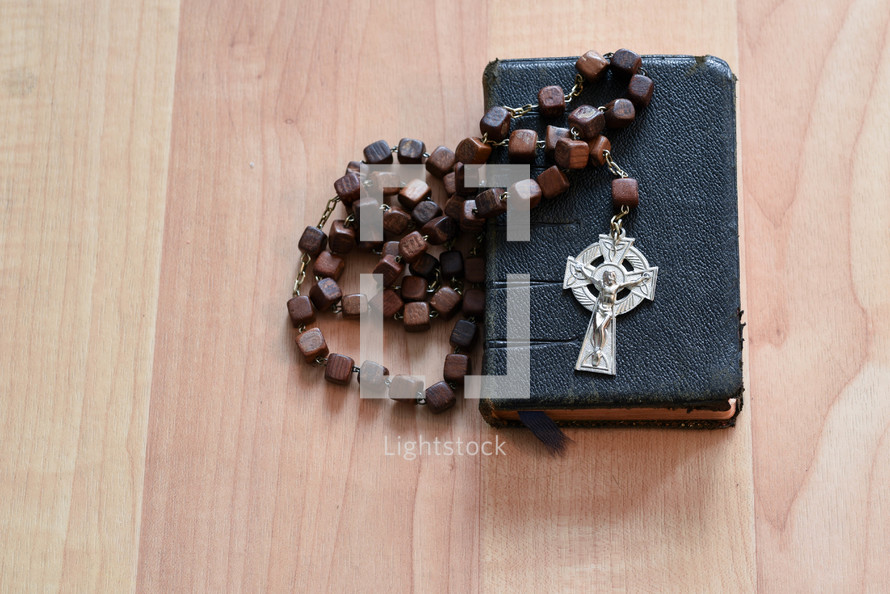 rosary beads on a Bible 