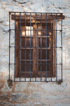 Iron bars over a wooden window.