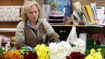 woman florist making flower arrangements 