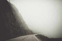 mountain road under thick fog