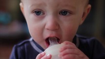 toddler drinking milk from a bottle 