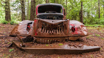 old rusty car in a forest 