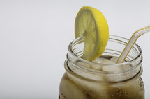 iced tea with lemon in a mason jar 