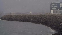 snow falling over a harbor in Iceland 