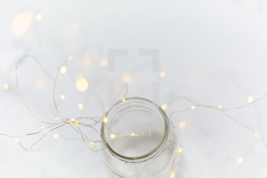 Jar with twinkle lights on a white background
