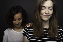 teen girls praying together 
