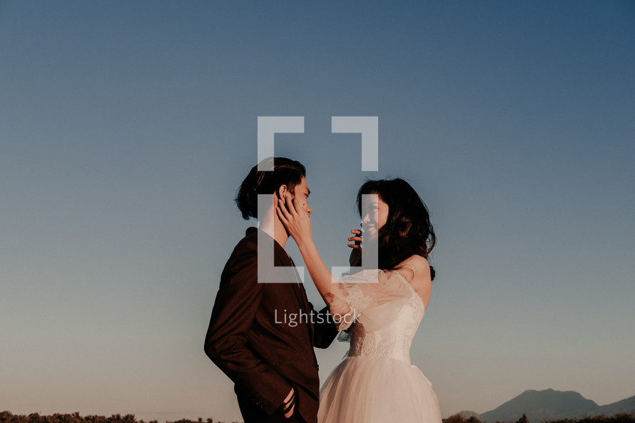 portrait of a bride and a groom with mountains in the background 