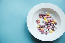 Easter candy in a bowl on a blue background