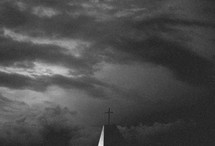a stormy sky at night with cross