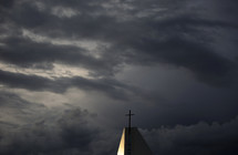 a church steeple in stormy skies