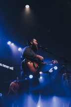 man singing during a worship service