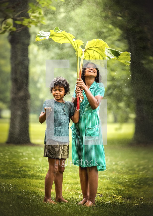 siblings standing in the rain 