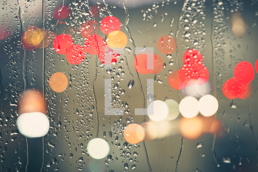 raindrops on the window and defocused street lights background