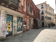 boarded up store fronts along a street in Italy 