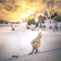 a boy pulling a sleigh 